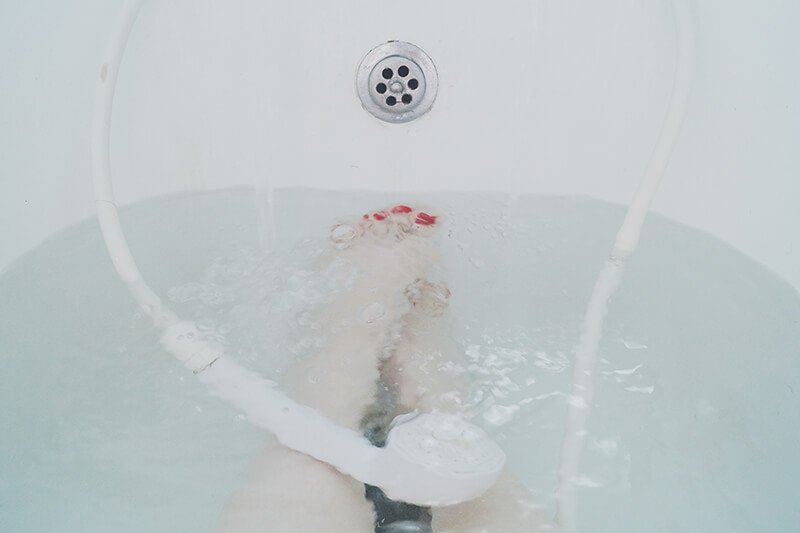 Feet in warm bath as a relaxing activity before bed