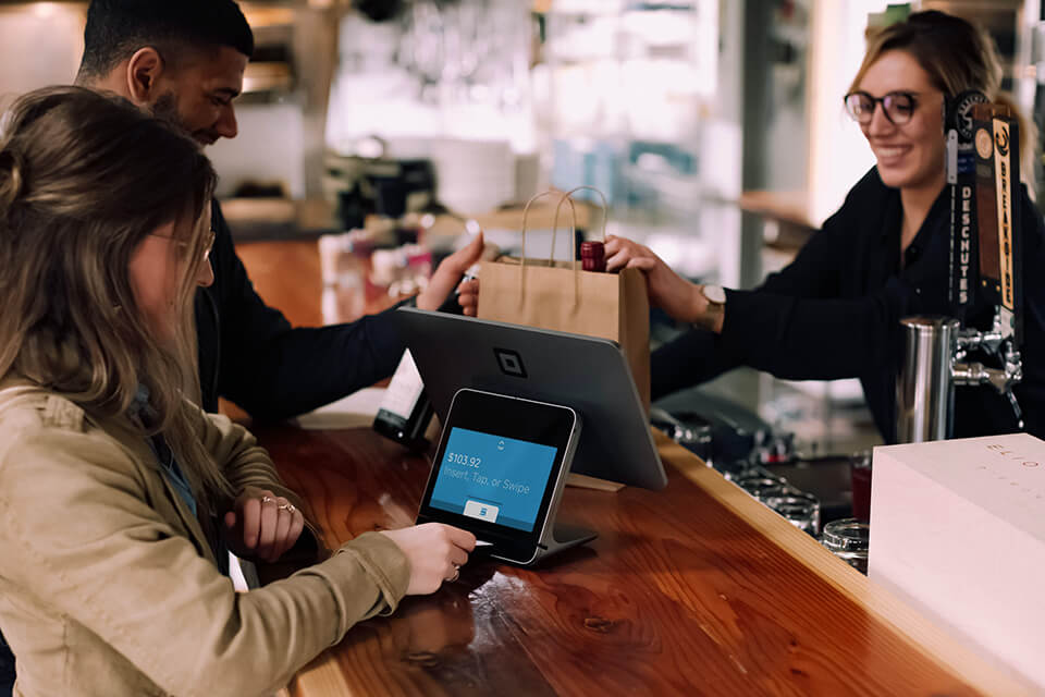 Woman using her credit card at a cashier