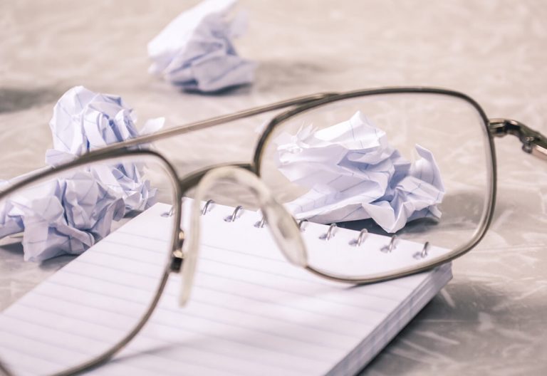 a pair of glasses sitting on top of a notebook.