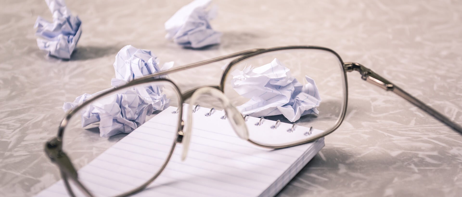 a pair of glasses sitting on top of a notebook.