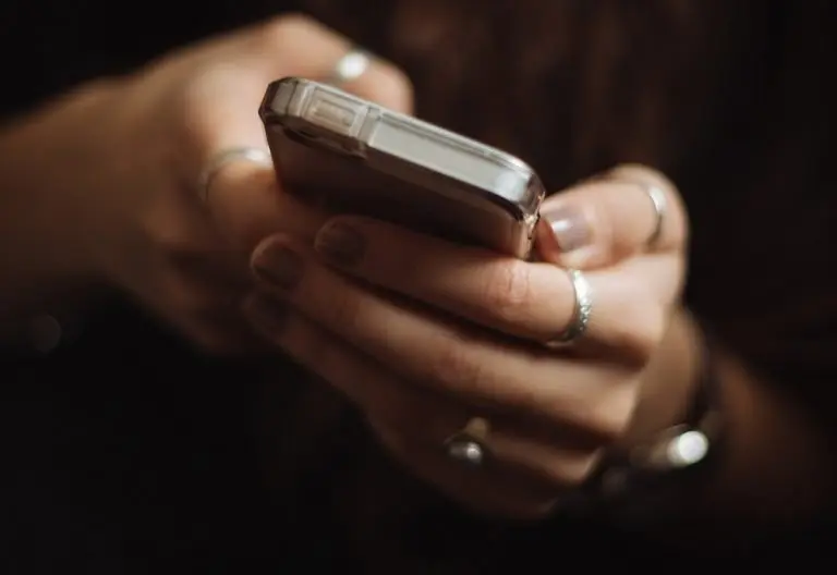 a close up of a person holding a cell phone.