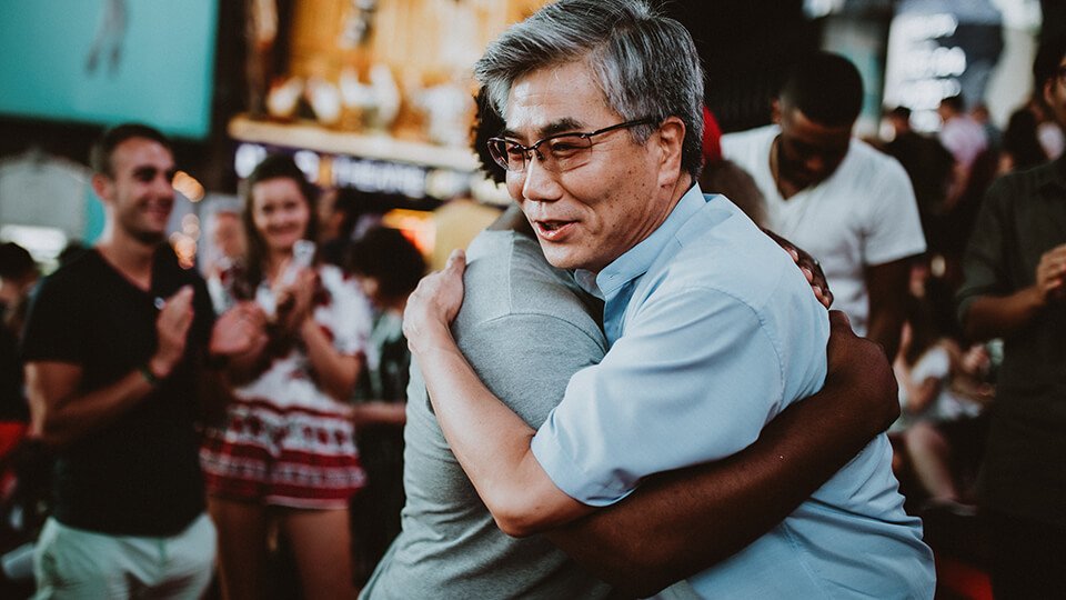 Two men hugging in the street