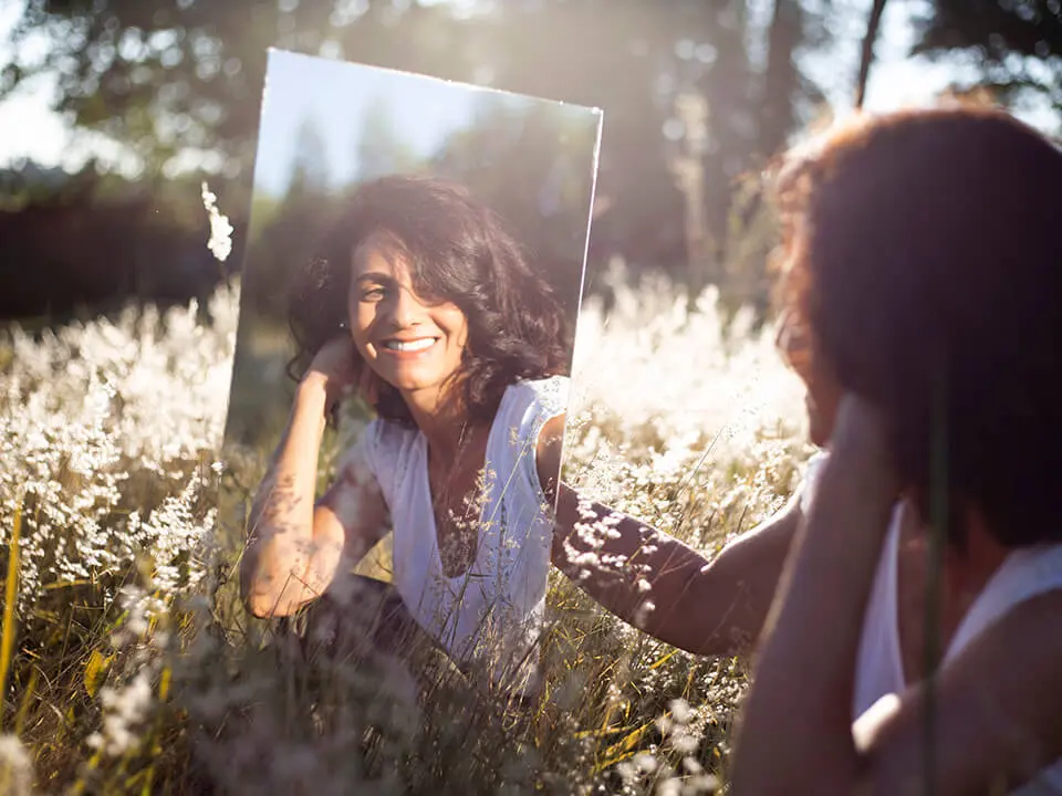 Woman looking at herself in the mirror