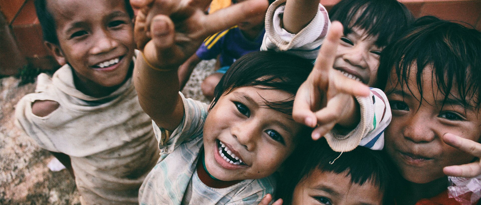 a group of young children standing next to each other.