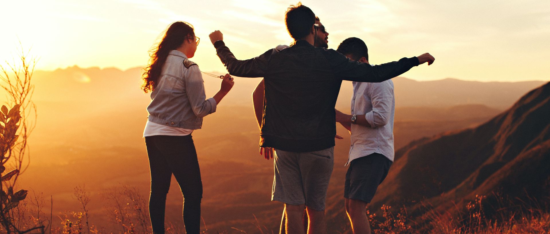 a group of people standing on top of a mountain.