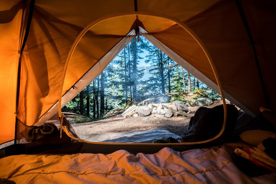 View from inside a tent, looking at the scenic outdoors