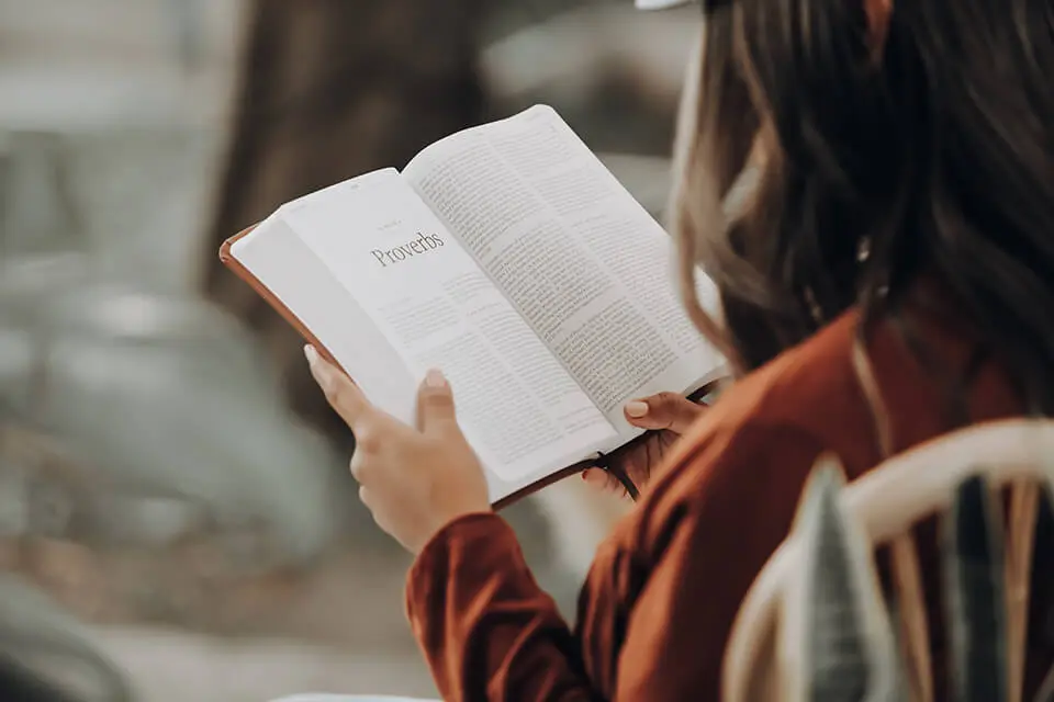 Woman reading a book outside