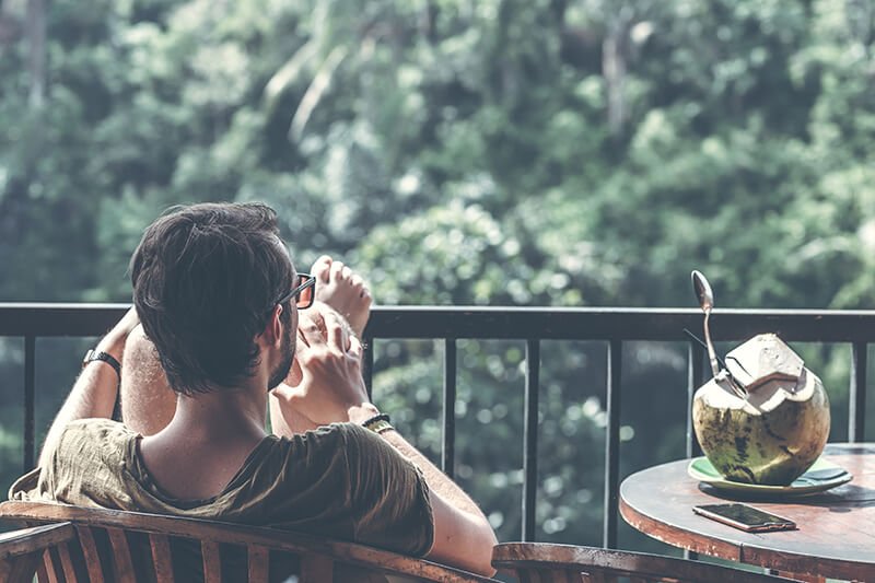 Man kicking back and relaxing on his porch