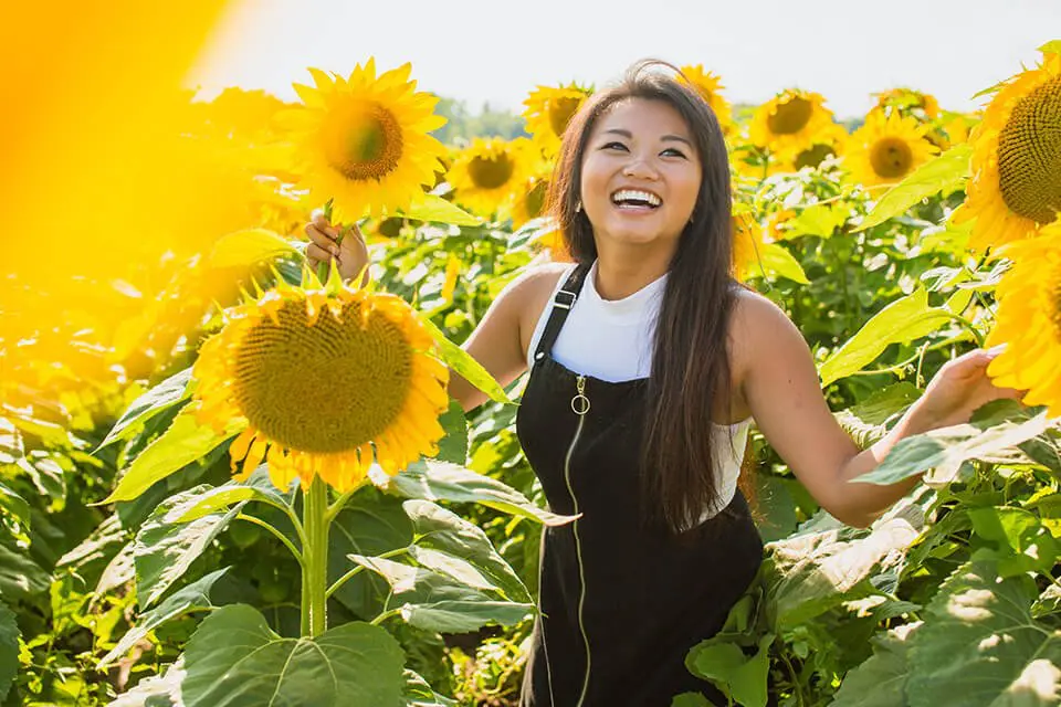 Woman smiling in a sunflower field