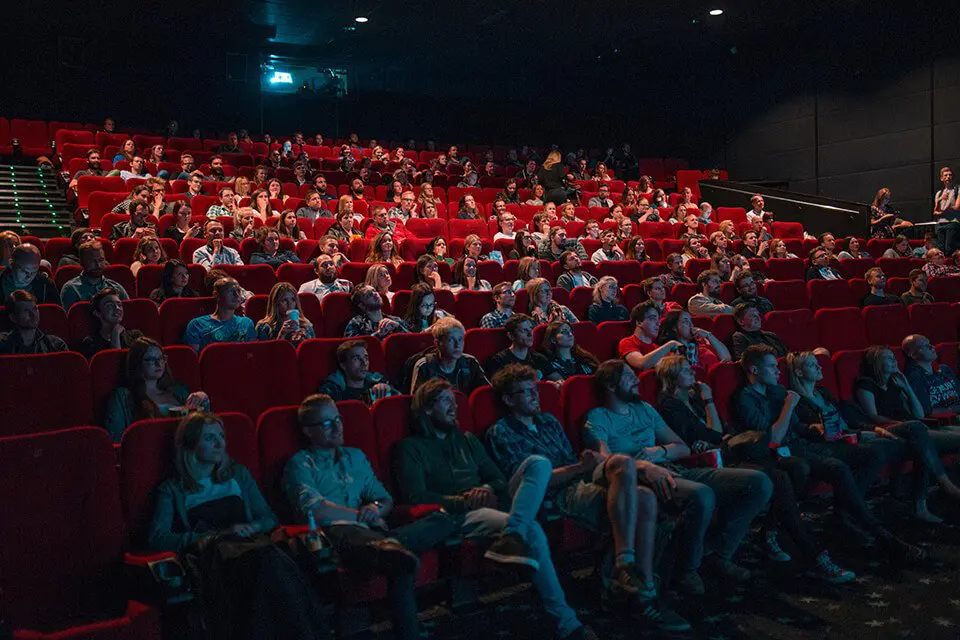 Watching something funny at a movie theater