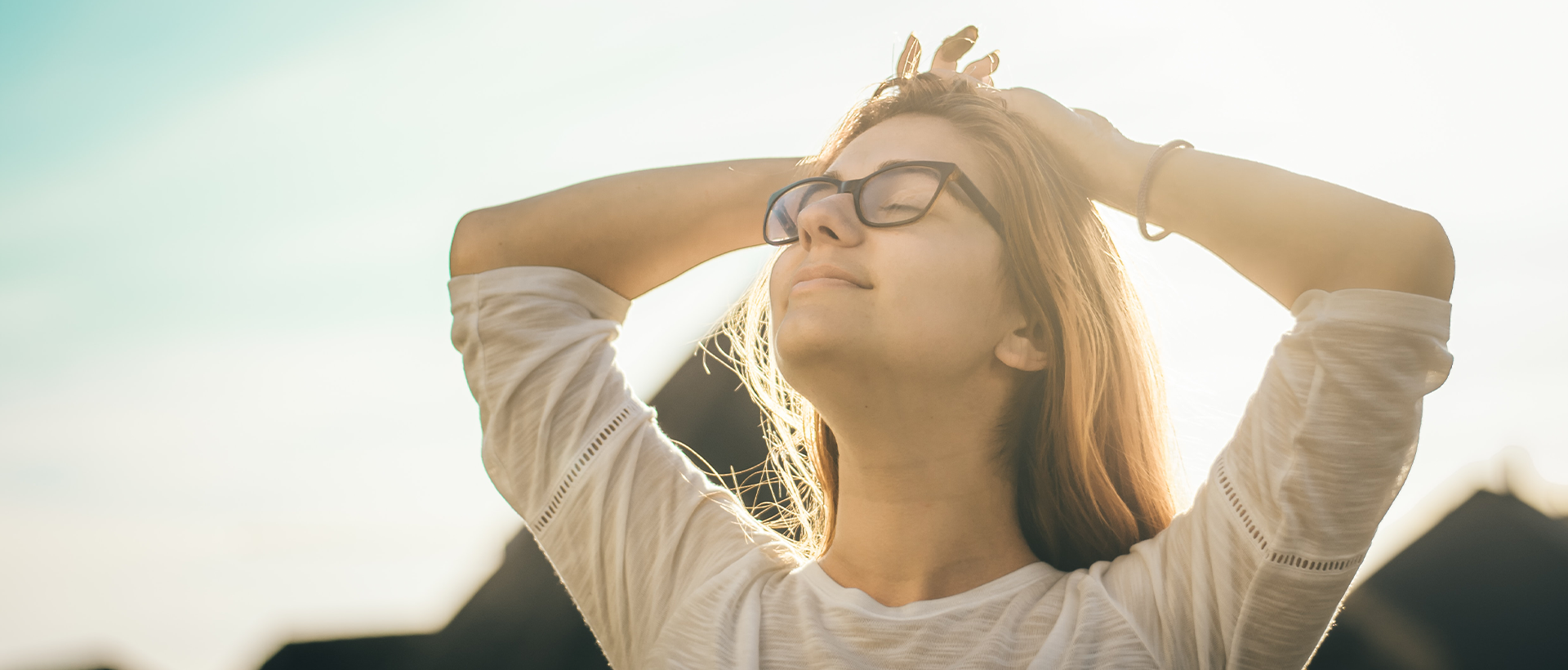 a woman with her hands on her head.